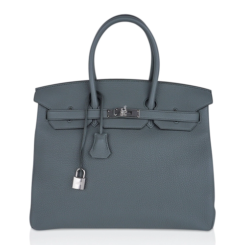 Muted Sage Grey-Green Pebble Grain Large Trapezoid Hand Tote With Cool Polished Silvery Twist Lock Hardware And Matching Textured Suspended Metal Padlock Charm