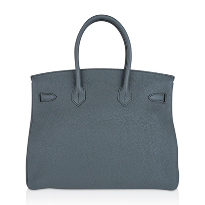 Muted Sage Grey-Green Pebble Grain Large Trapezoid Hand Tote With Cool Polished Silvery Twist Lock Hardware And Matching Textured Suspended Metal Padlock Charm