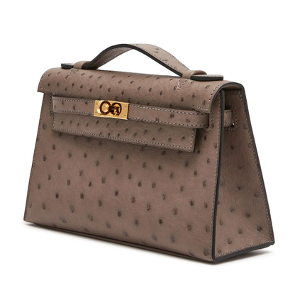 Soft Muted Taupe Grey Dotted Grain Compact Trapezoid Mini Clutch With Warm Golden Turnlock Hardware And Side Carry Attachment Ring
